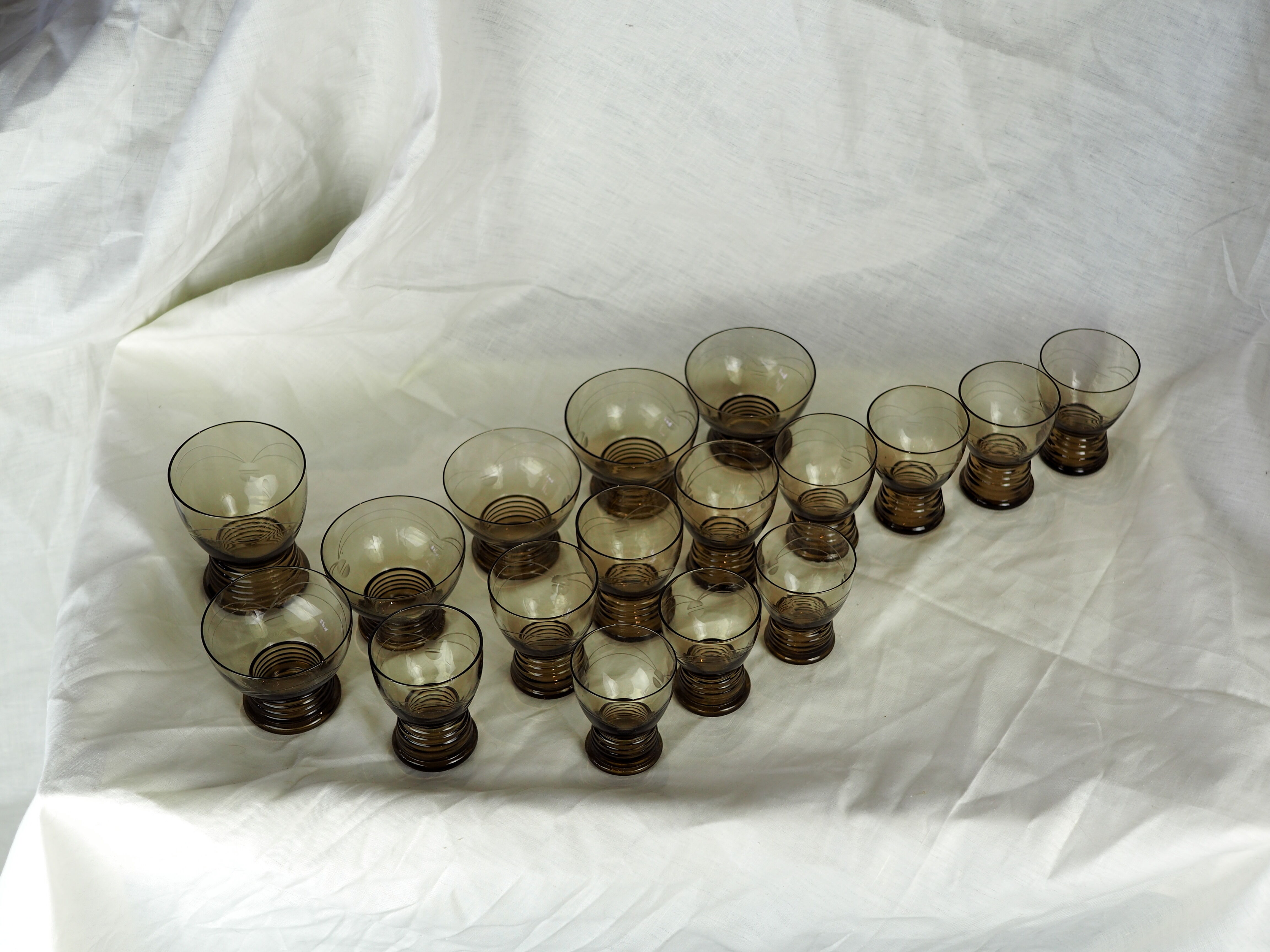 Set of 17 black smoked glasses on geometric engraving stand - 70s