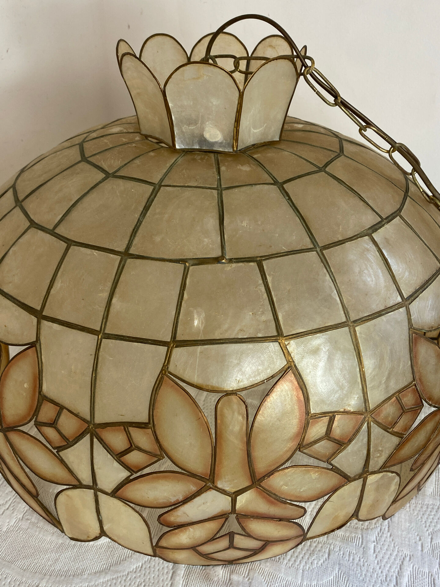 Large mother-of-pearl and brass chandelier with floral decoration.