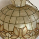 Large mother-of-pearl and brass chandelier with floral decoration.