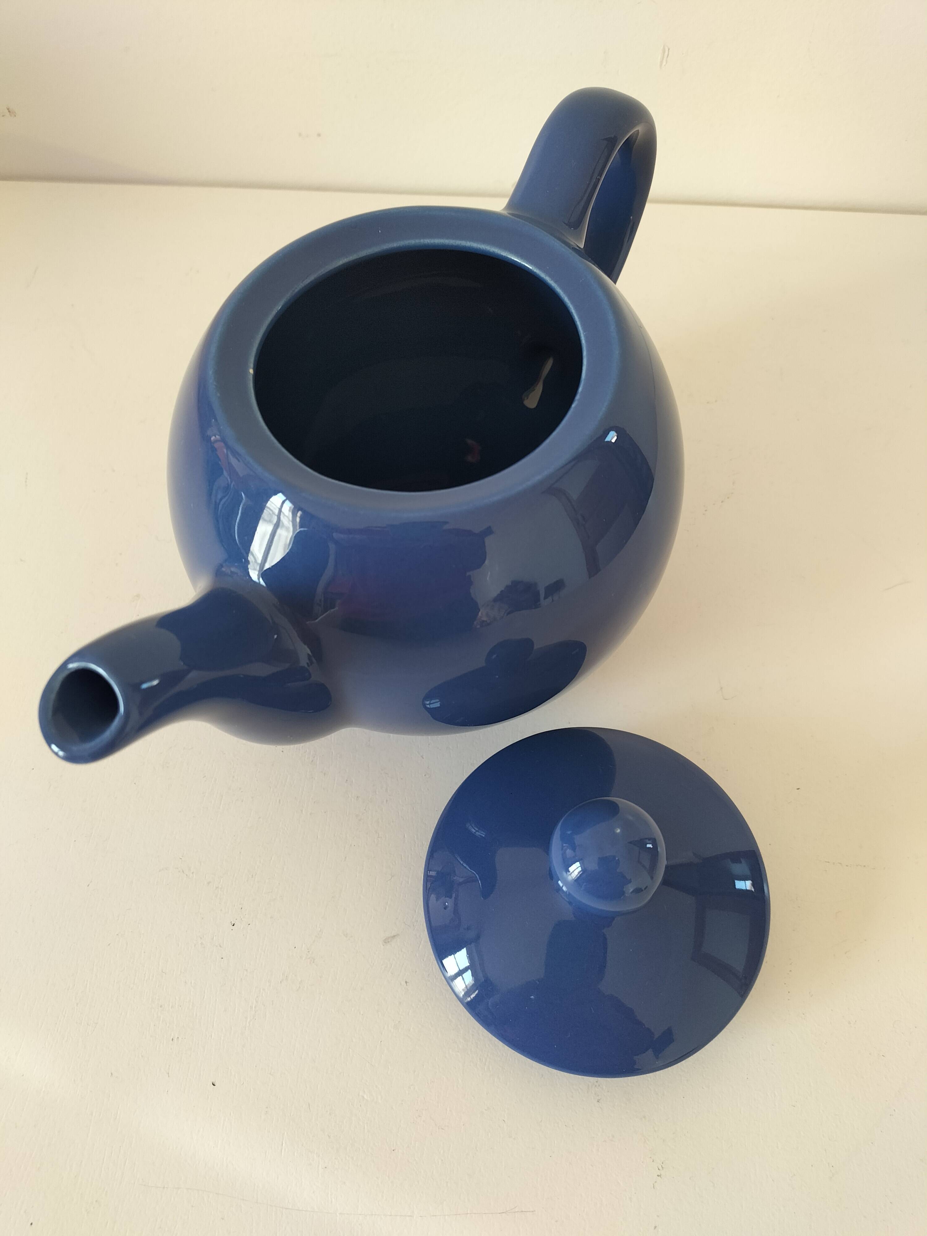 Vintage deep blue teapot, minimalist round shape.