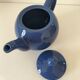 Vintage deep blue teapot, minimalist round shape.
