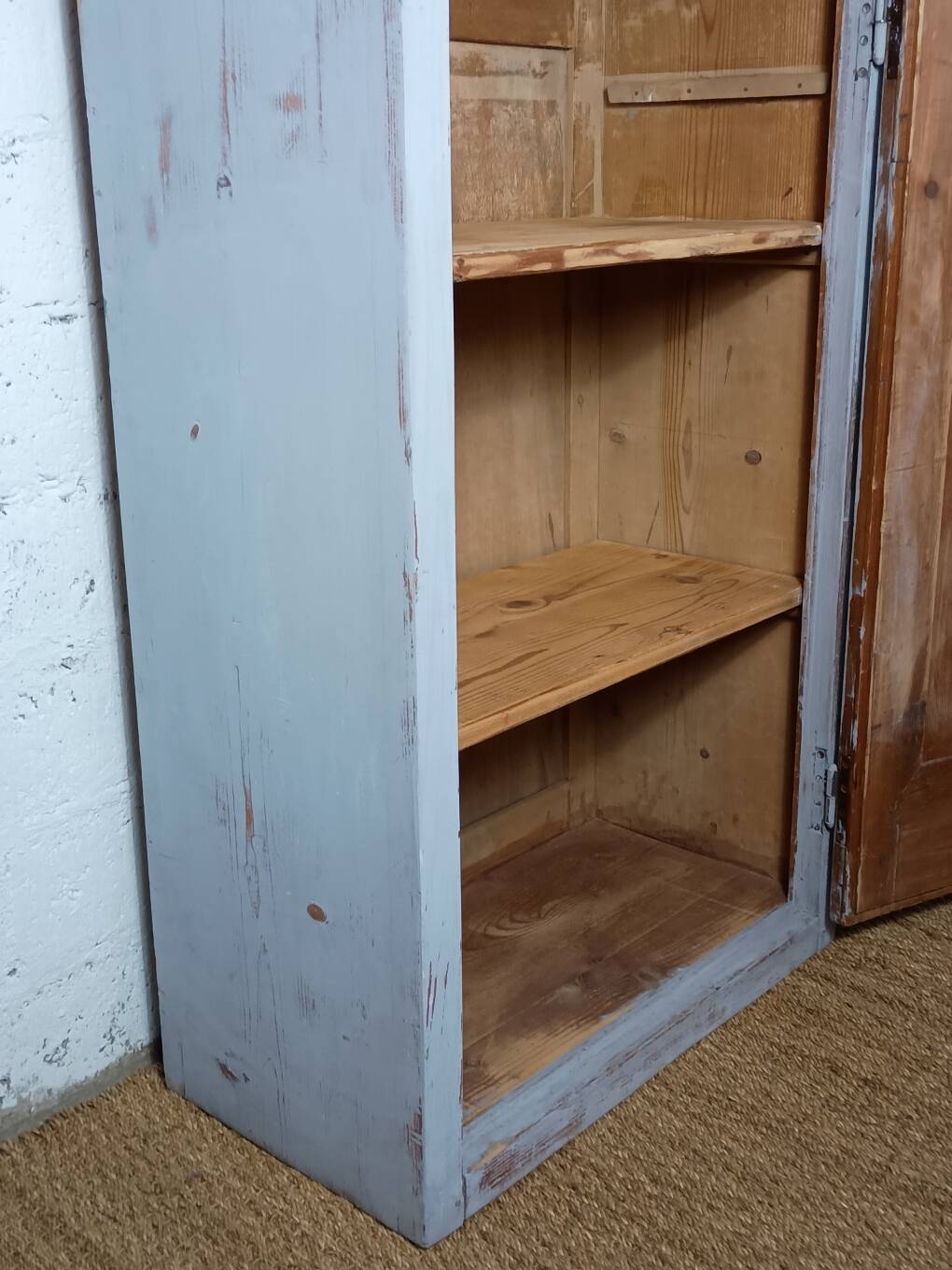 Rustic antique bonnetière in weathered blue-grey wood.