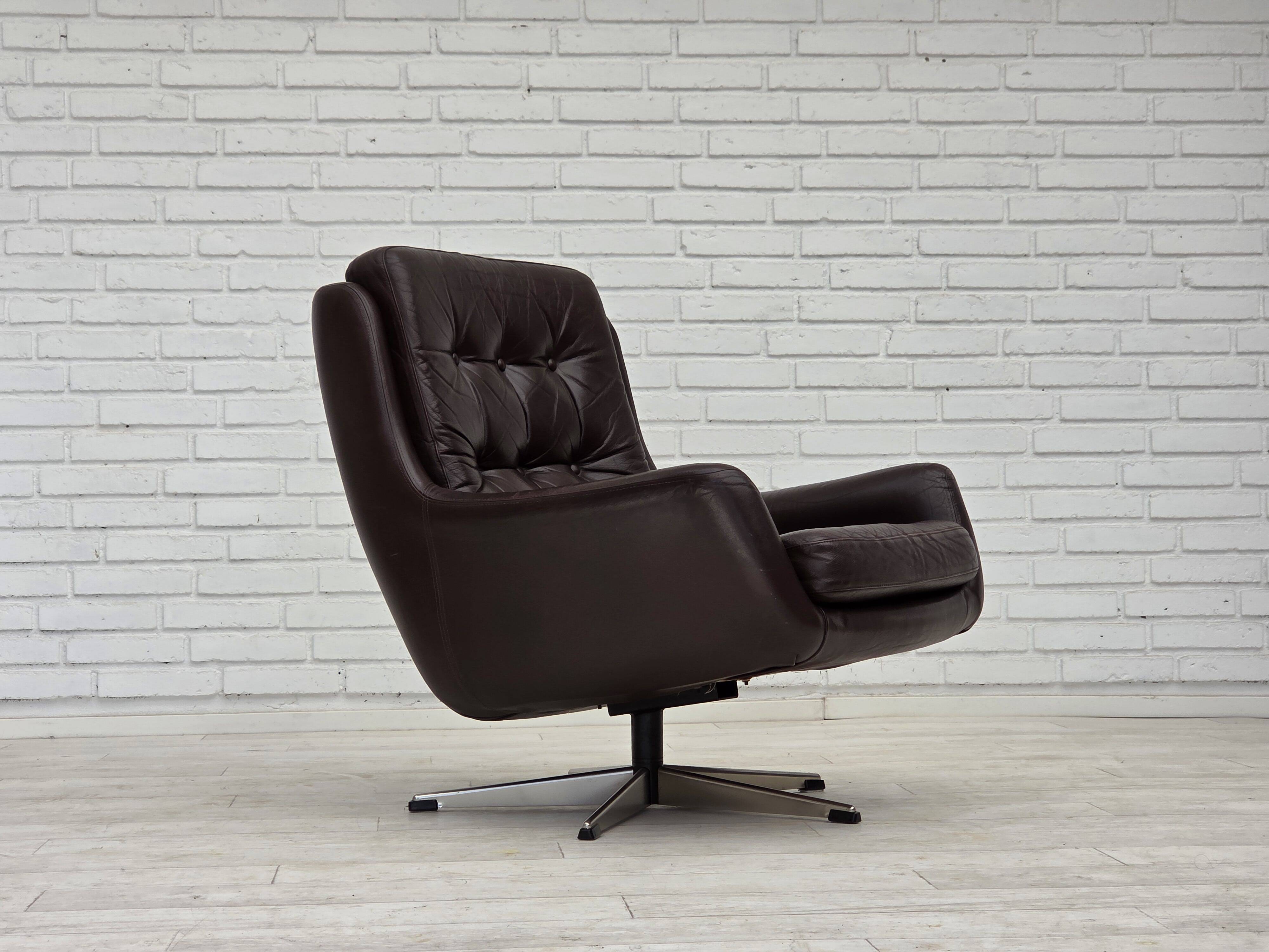 1970s, set of two swivel lounge chairs with footstool, leather.