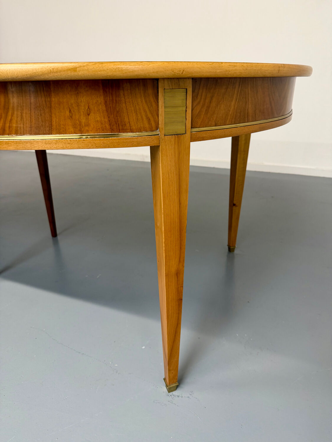 Round walnut Napoleon III extendable table with bronze top in good condition.