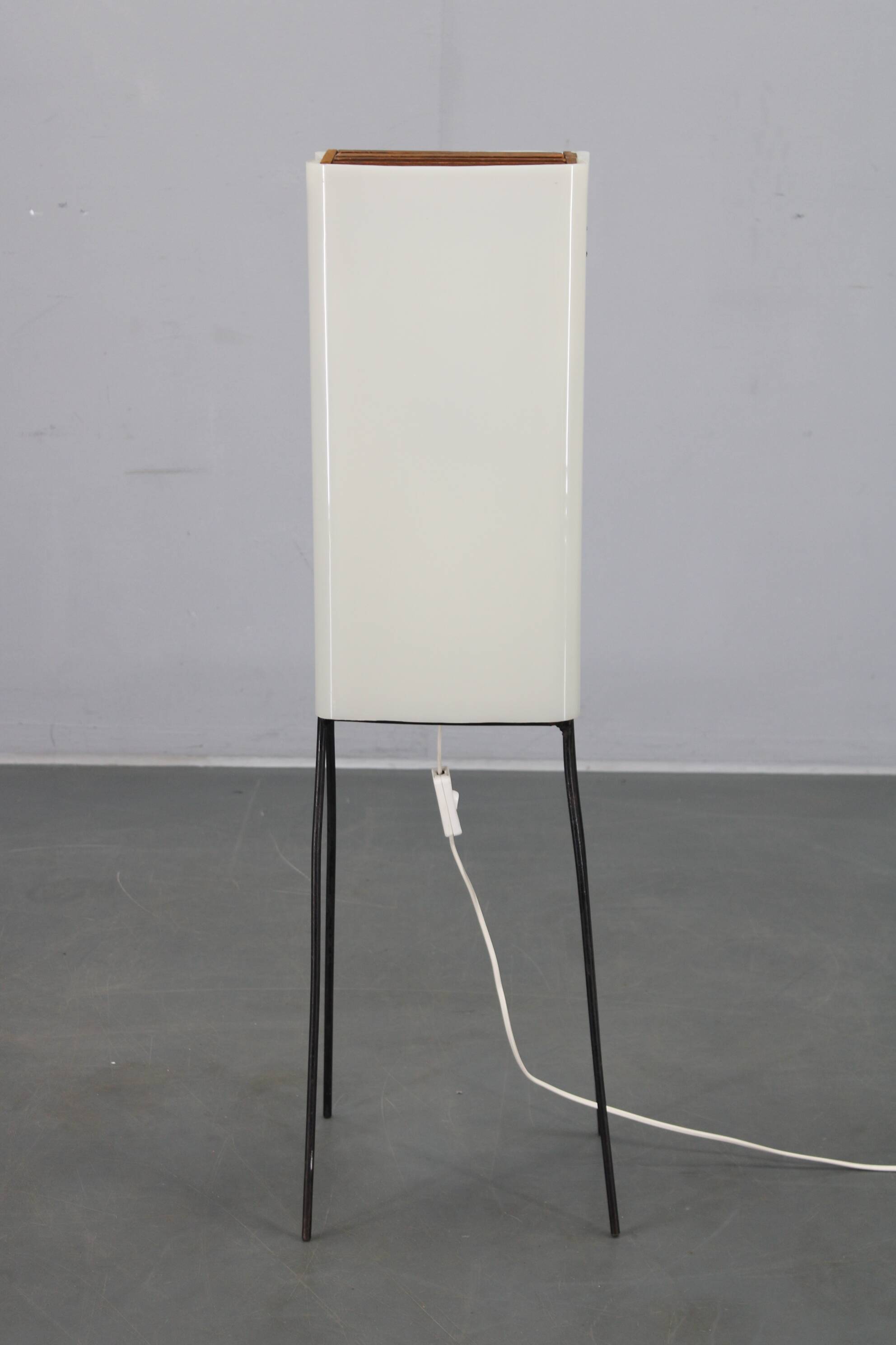 Mid-century modern floor lamp on iron legs with plastic shade and wood accent