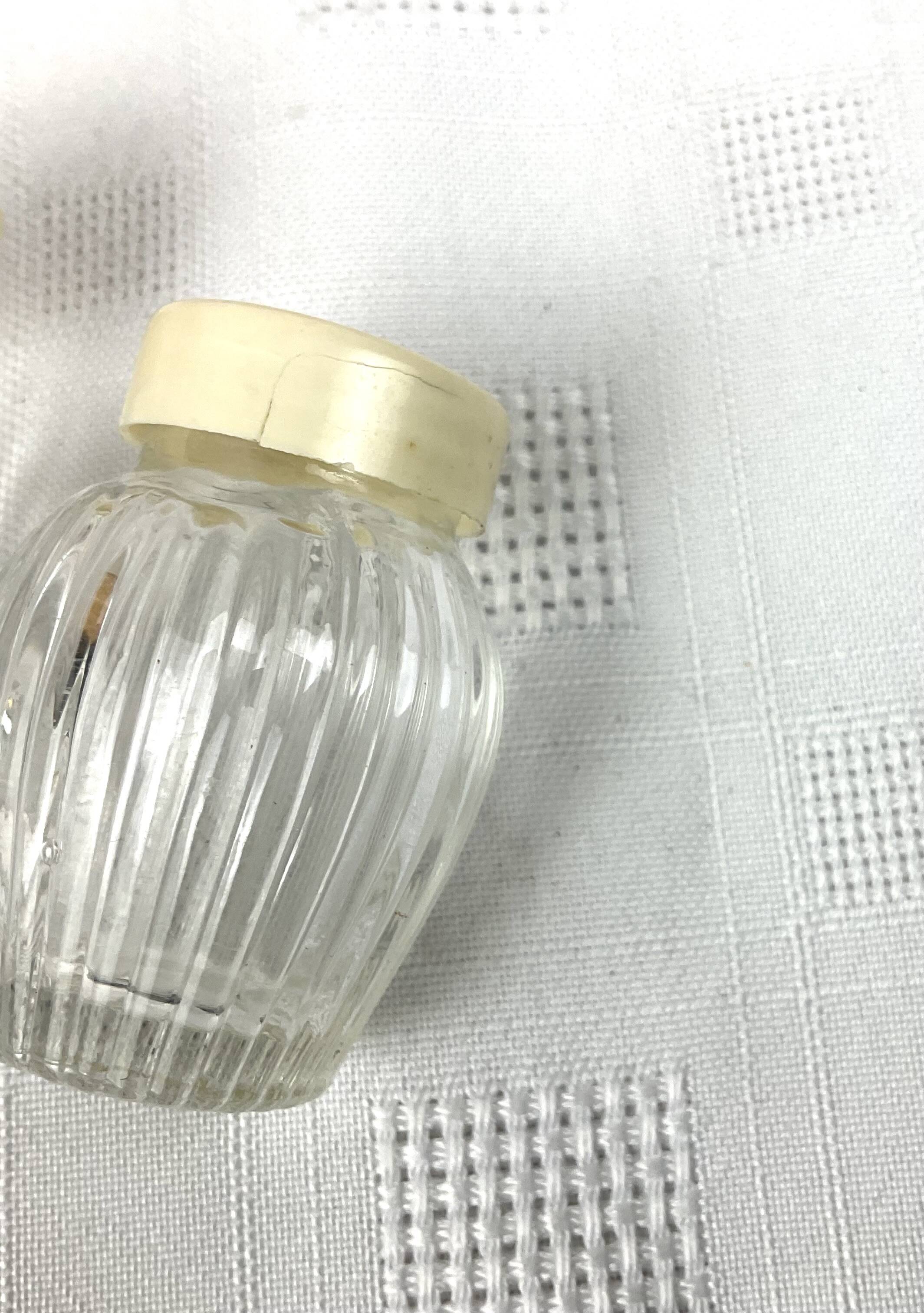 Vintage salt and pepper shakers and their chrome metal support