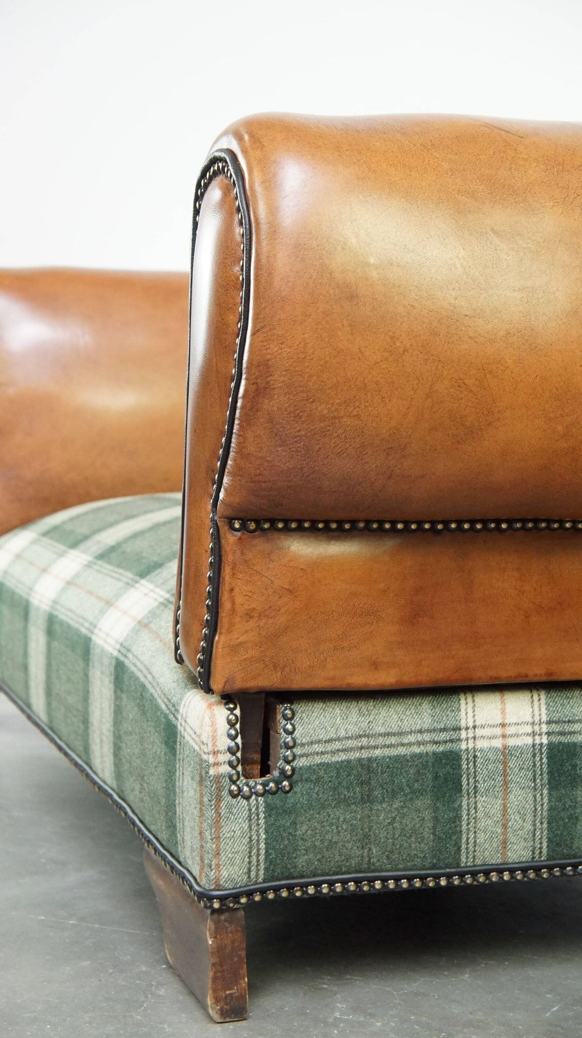 Antique daybed reupholstered with sheepskin and Scottish tartan wool