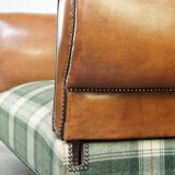 Antique daybed reupholstered with sheepskin and Scottish tartan wool