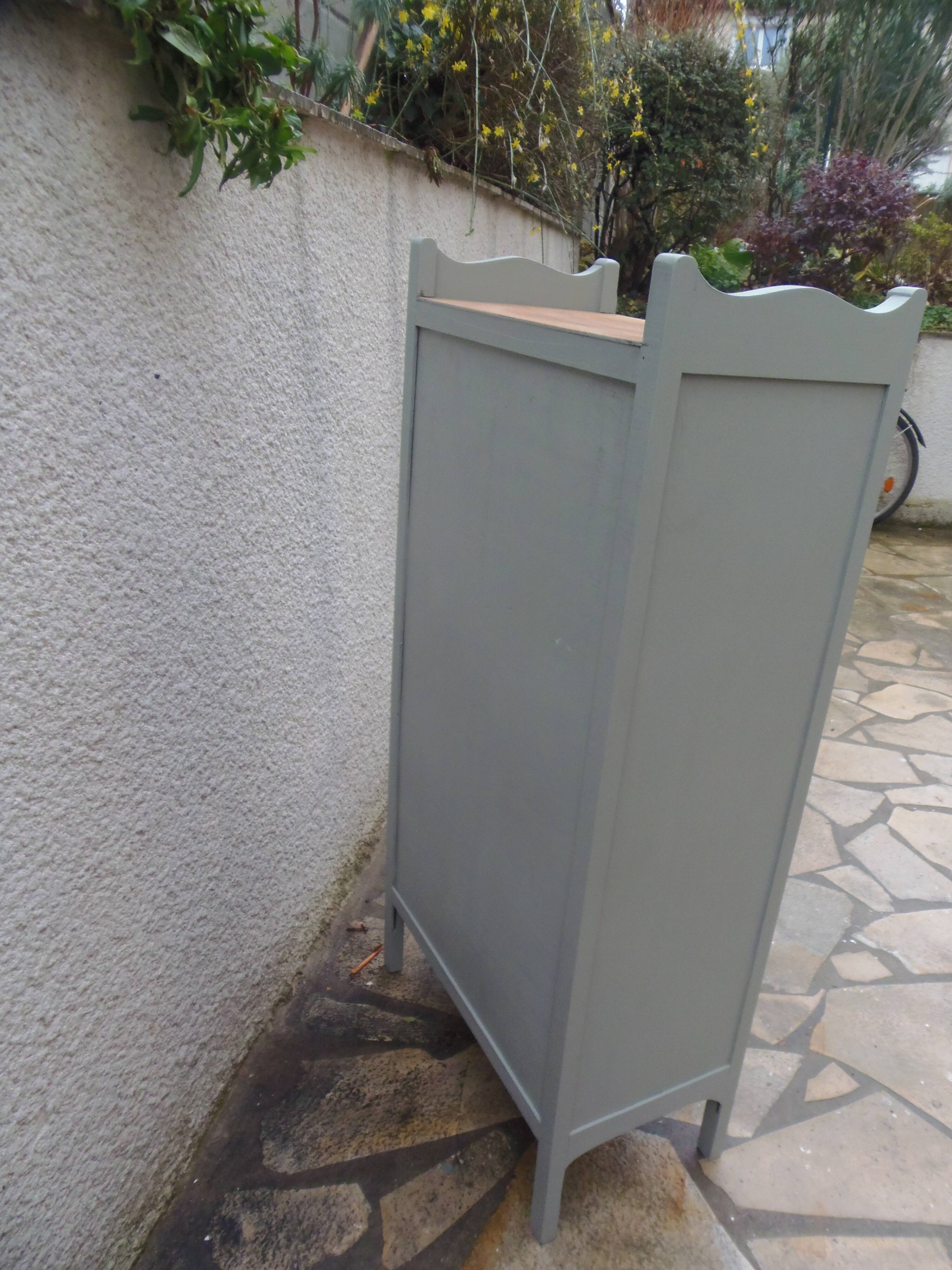 Vintage furniture of shallow depth re-enchanted in grey-green.