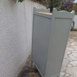 Vintage furniture of shallow depth re-enchanted in grey-green.