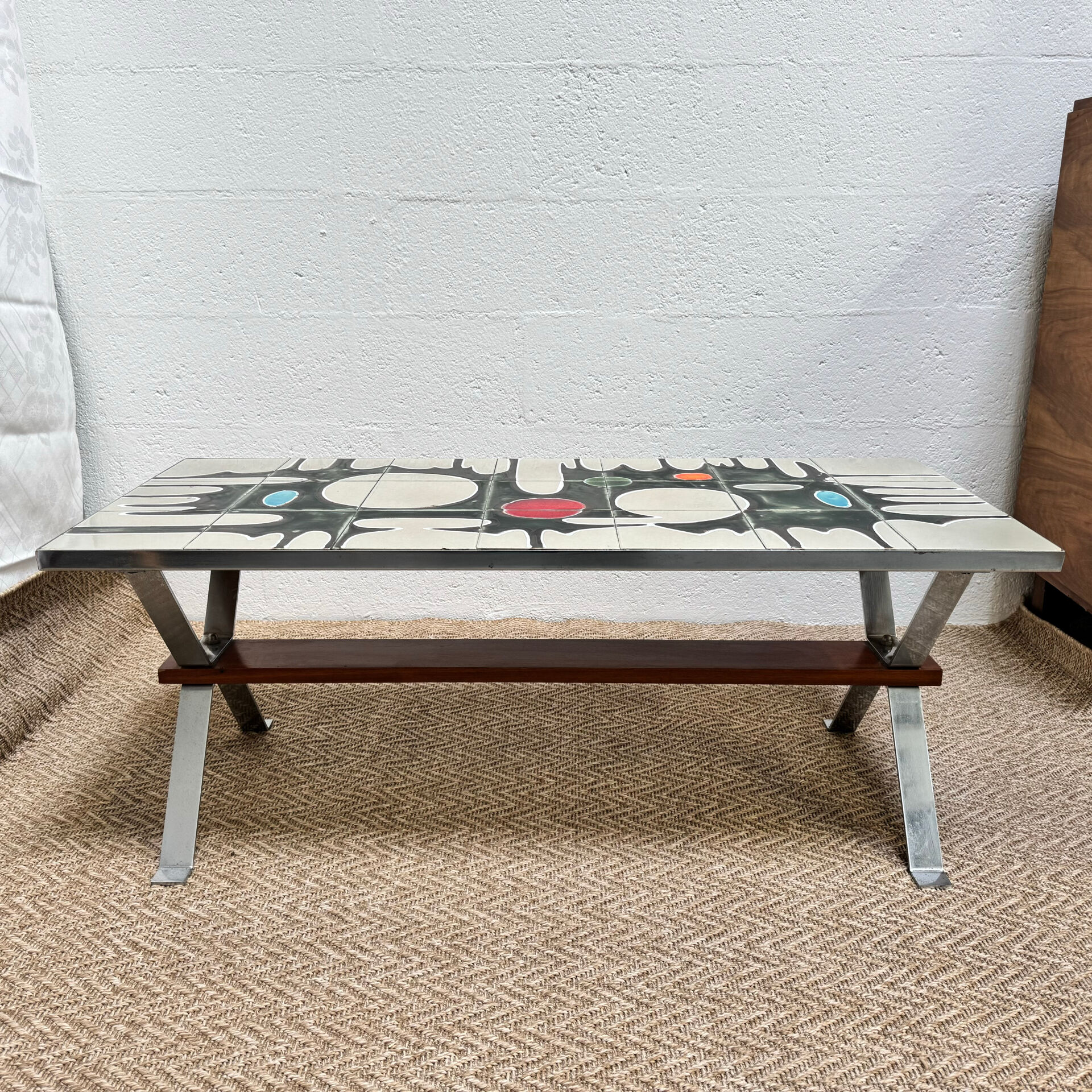 Vintage coffee table from the 60s and 70s in ceramic, chrome metal, and wood.
