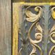 Rectangular Indonesian construction element with blue and yellow plant in carved wood