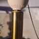 A pair of vintage table lamps featuring a turned wooden base, accessories...