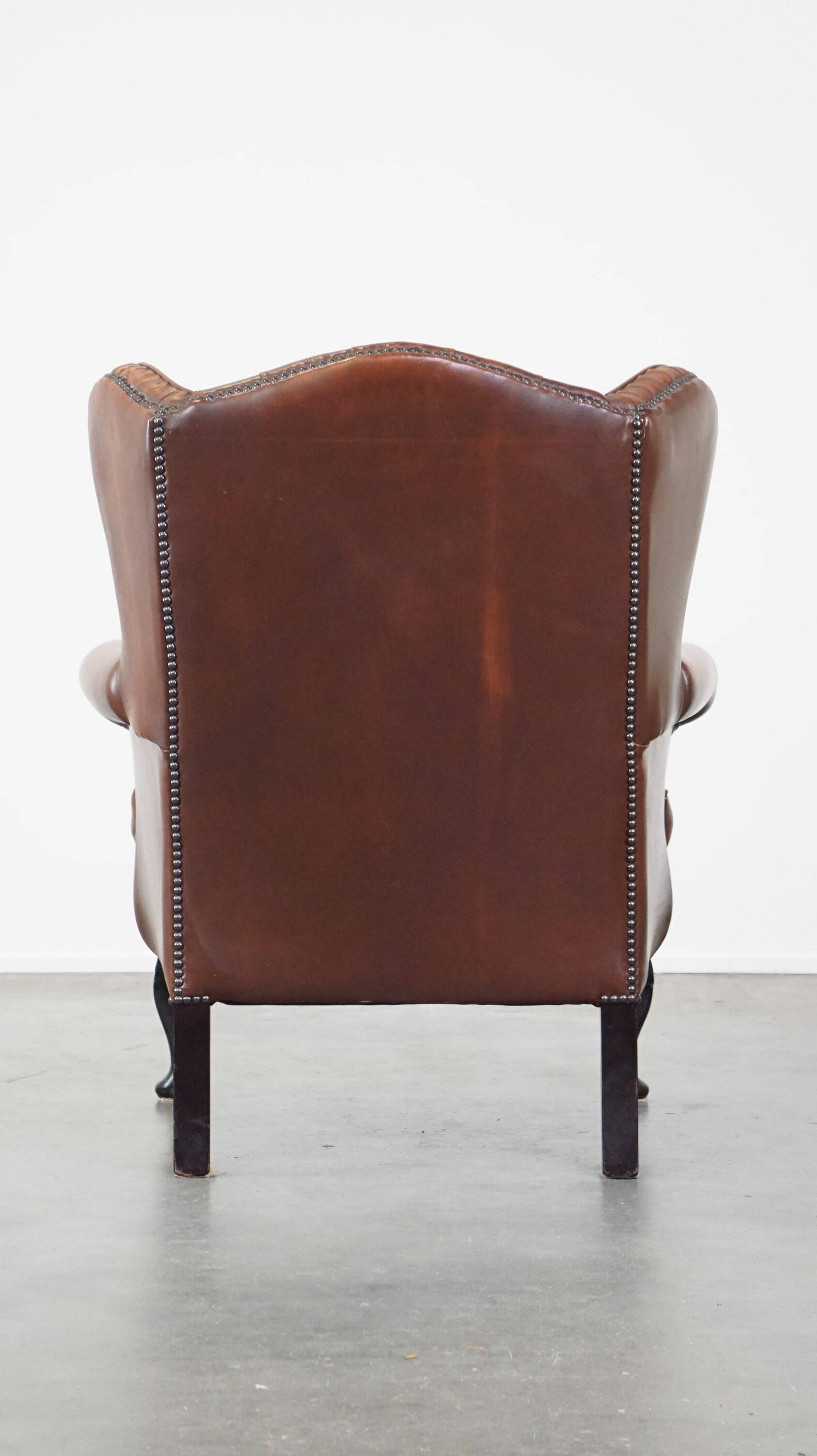 Brown leather wingback Chesterfield armchair