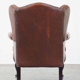 Very beautiful, stately, cowhide Chesterfield wing chair with elegant legs in a nice brown color
