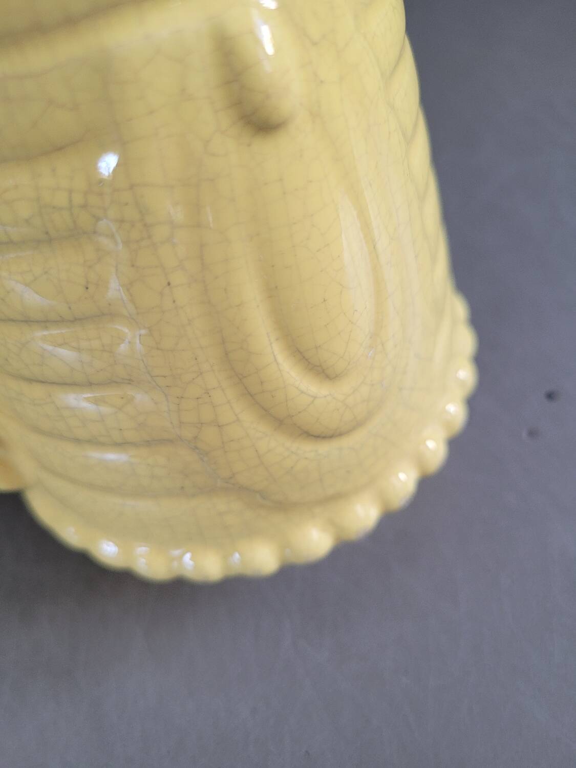 Yellow milk jug with reliefs