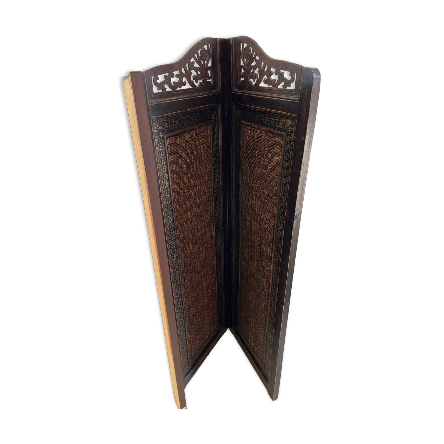 Antique wooden wall panel with carving and cane in an Asian style.