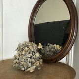 Old oval mirror with wooden frame