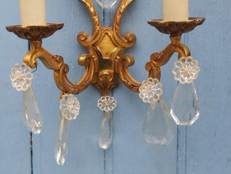 French antique Louis XV style twin arm wall sconces in bronze with crystals.