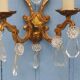 French antique Louis XV style twin arm wall sconces in bronze with crystals.