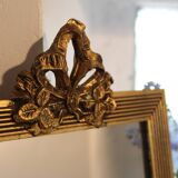 Small rectangular mirror in gilded wood with a pediment decorated with flowers