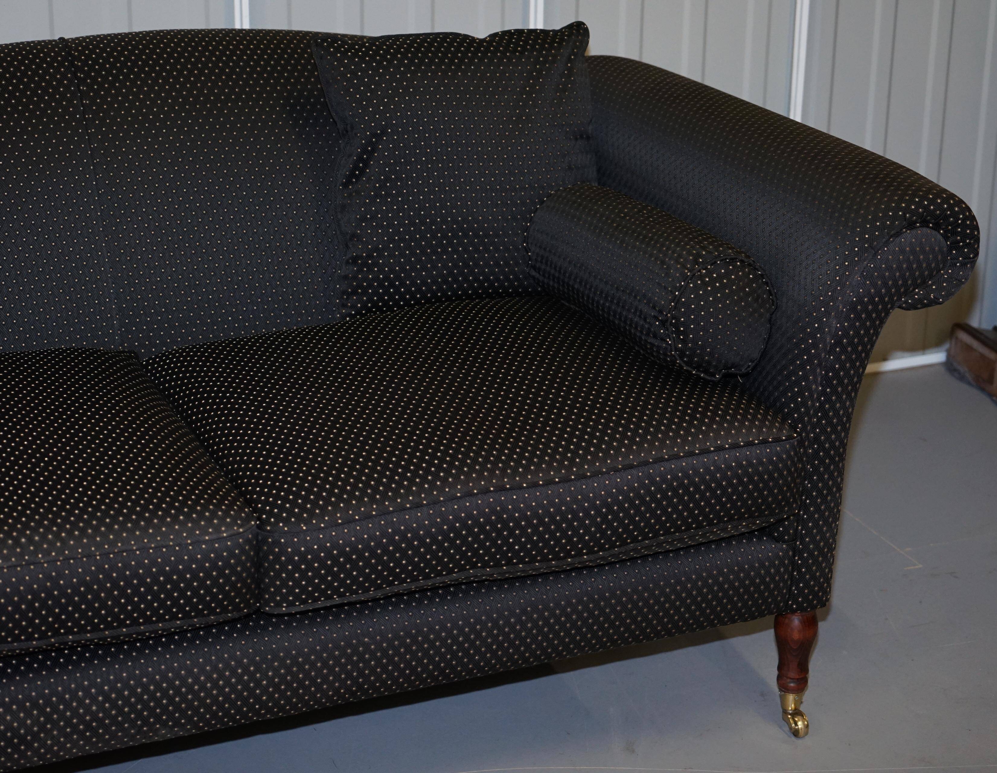 Three-seater Art Deco canapé with a light hardwood frame.