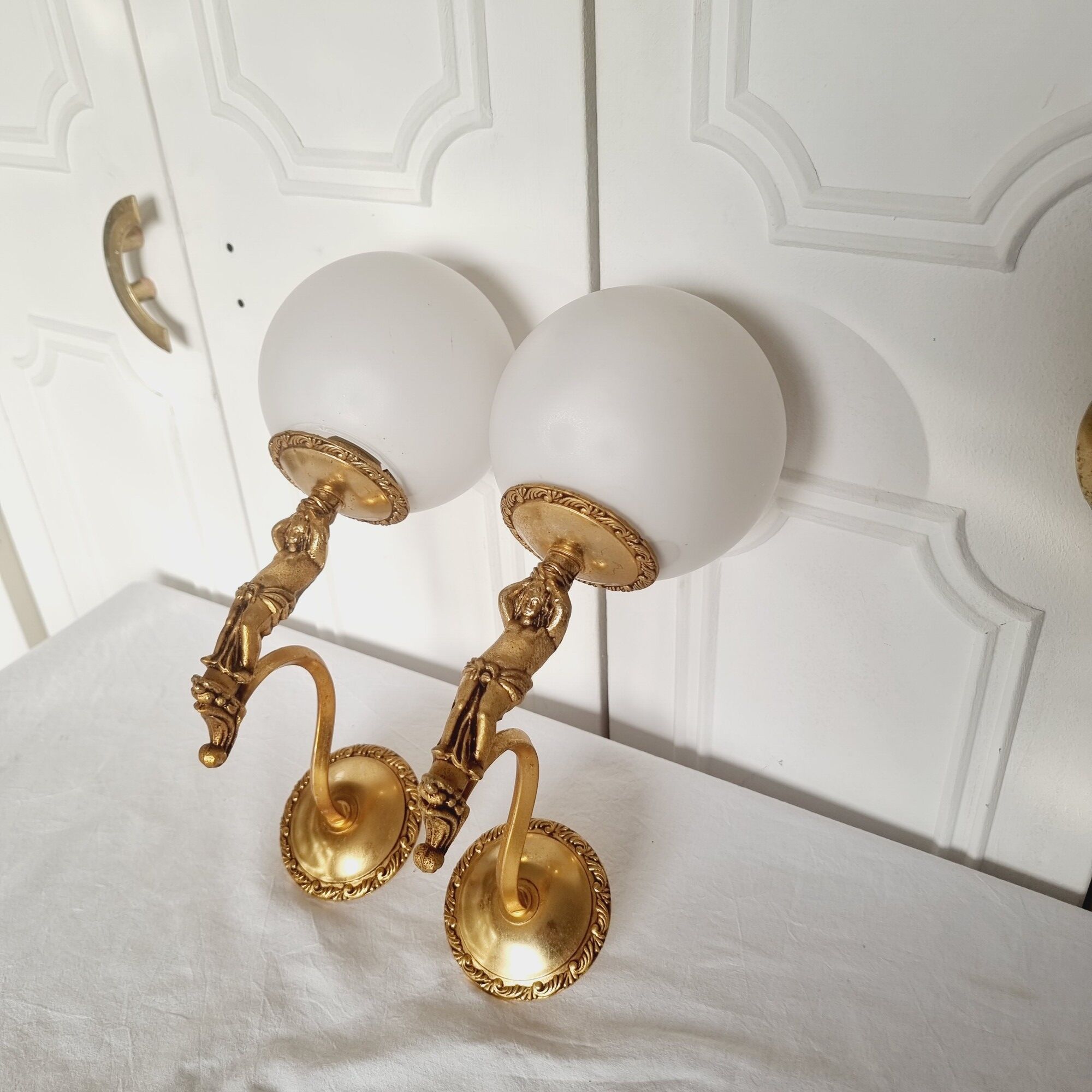 2 classic golden cherub wall lights and globe lampshades in perfect condition.