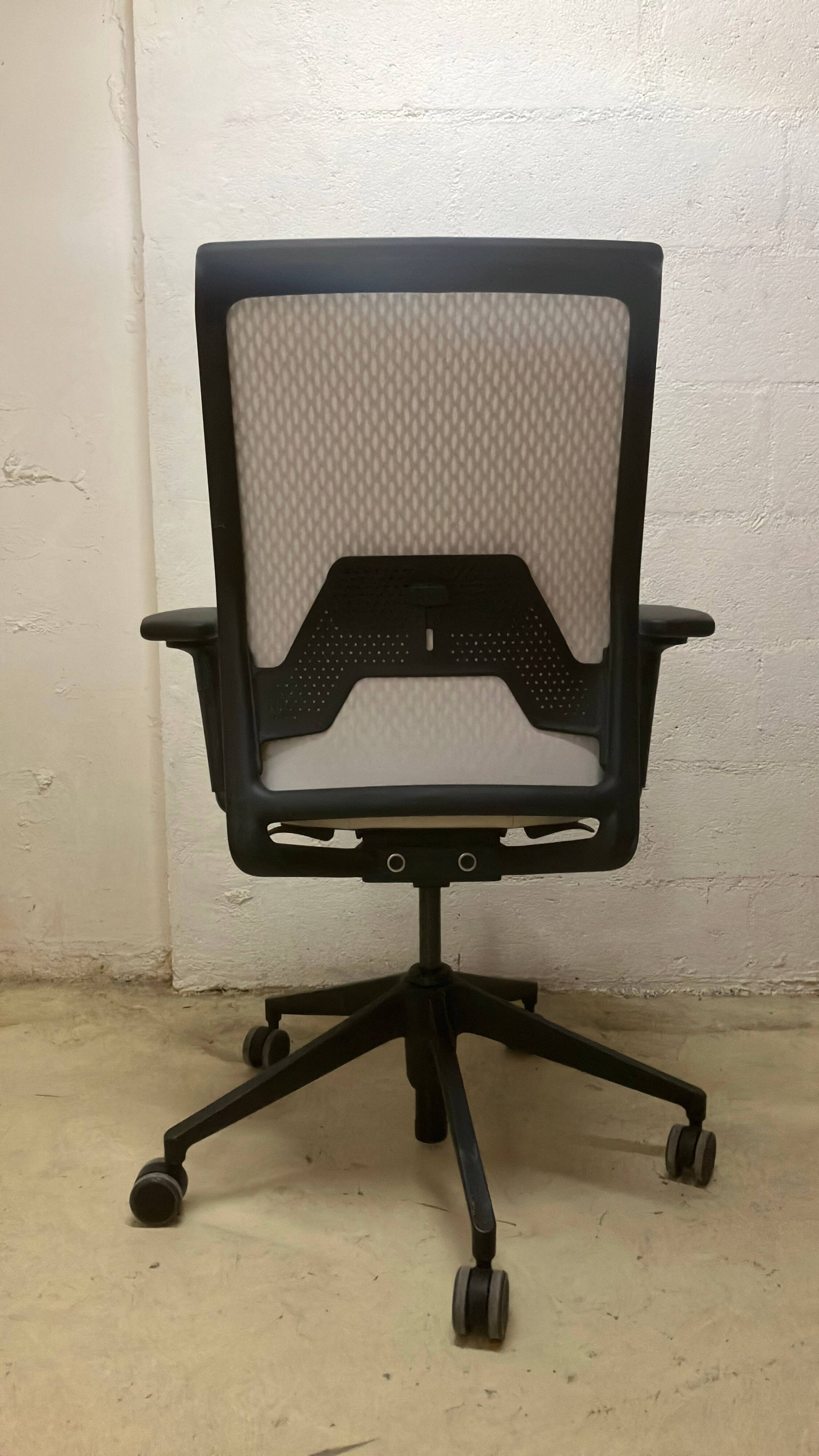 Office chair with wheels and mesh backrest.