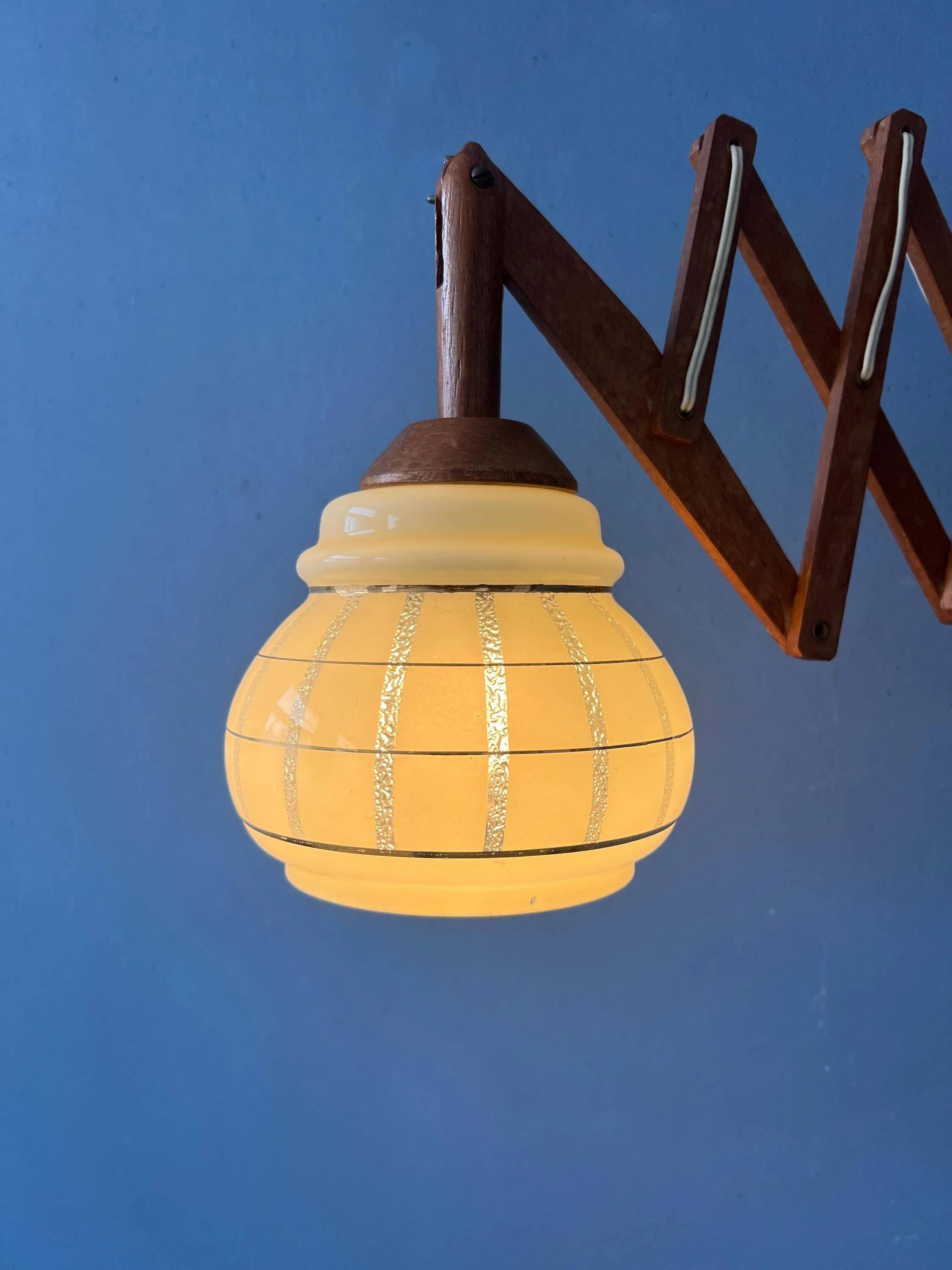Vintage wall lamp with teak wood scissors and glass shade.