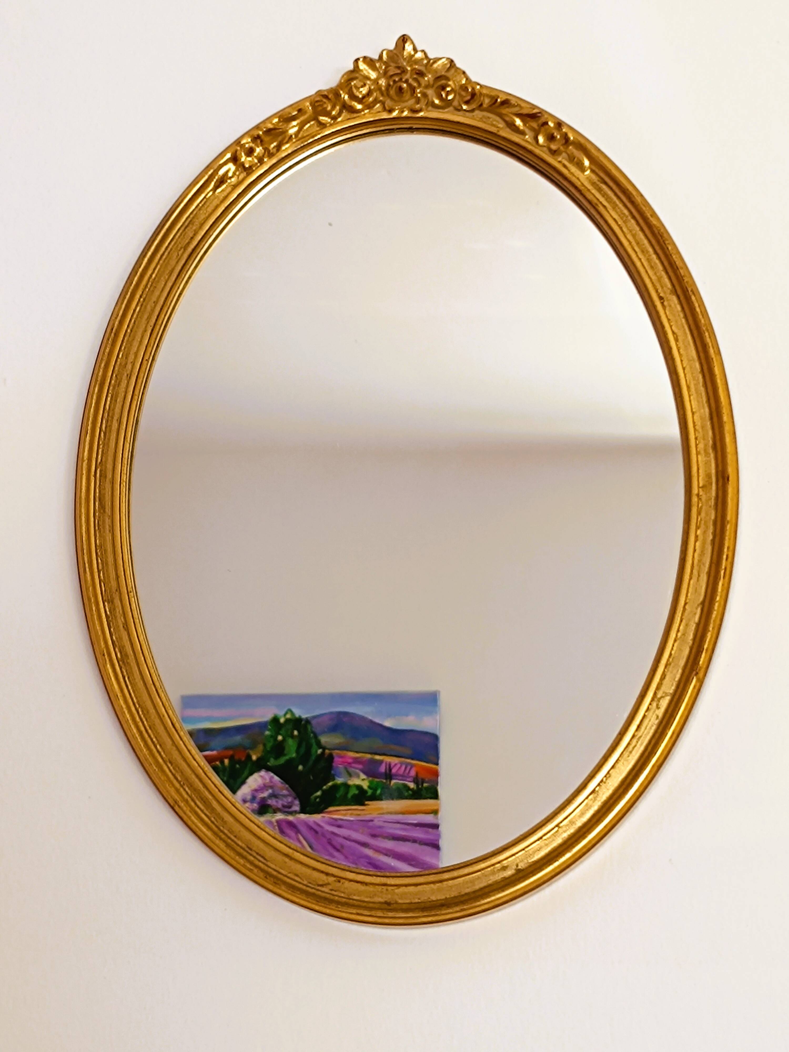 Antique oval-shaped gilded mirror