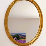 Antique oval-shaped gilded mirror