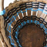Vintage wooden basket with round handle, blue and black weaving.