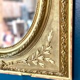 Mirror XIXth medallion on gilded frame with leaf
