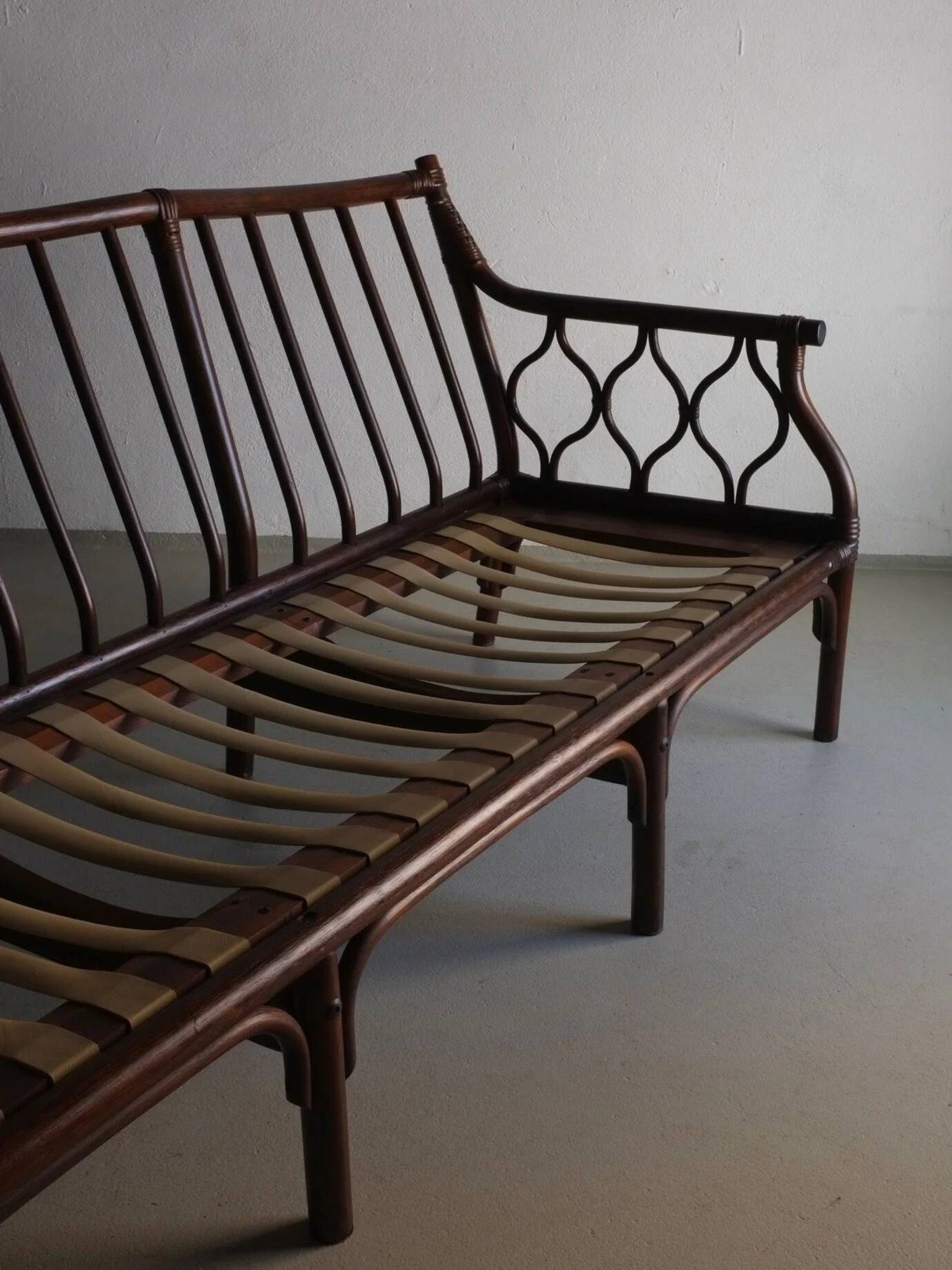 Dark rattan 3-seater sofa with red velour cushions | 1980s