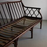 Dark rattan 3-seater sofa with red velour cushions | 1980s