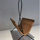 Rattan and black lacquered metal magazine rack