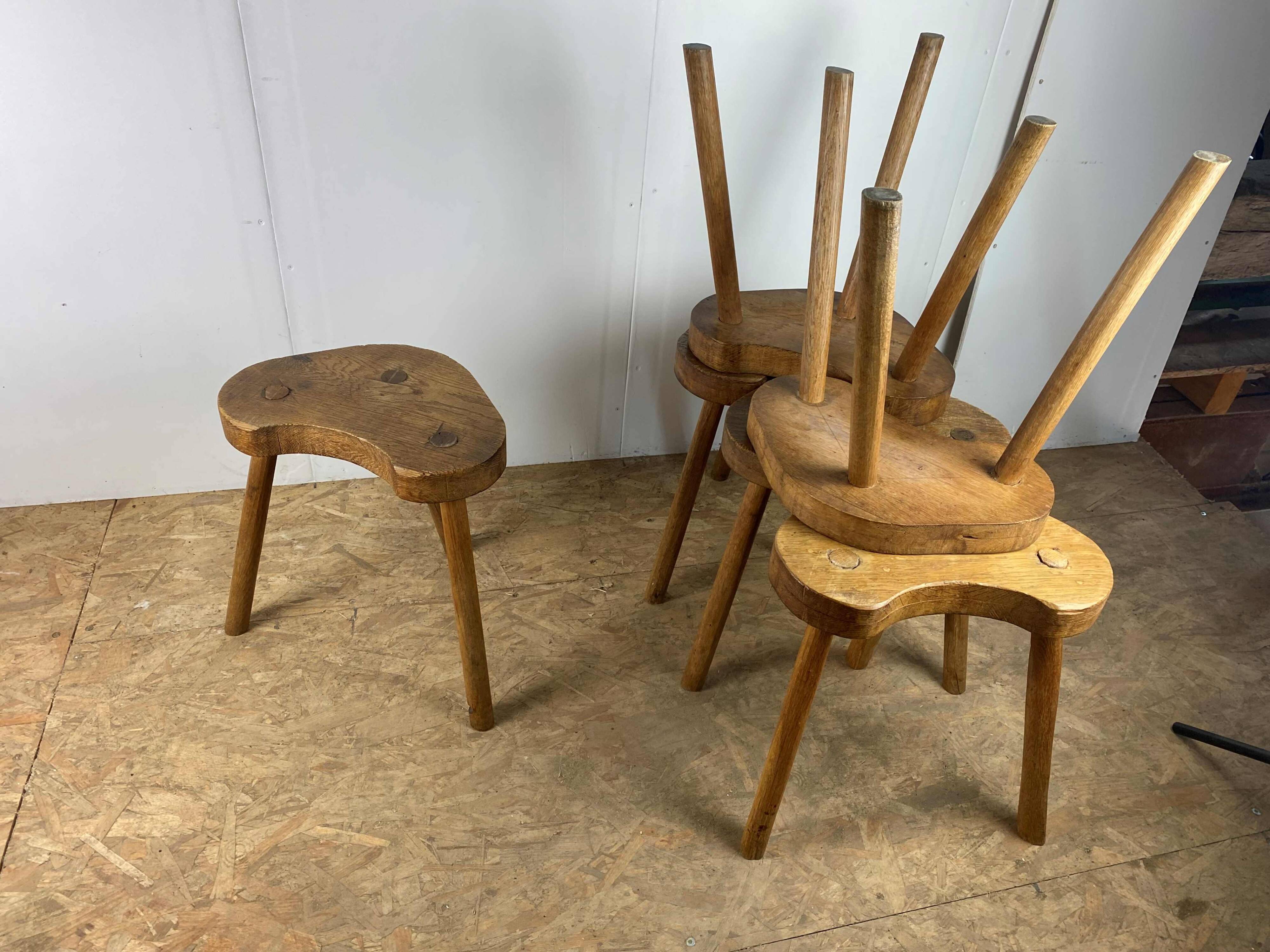 Set of 6 brutalist solid oak tripod farm stools from the 1950s