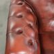 Vintage set of 2 cowhide leather Chesterfield armchairs in a brown colour