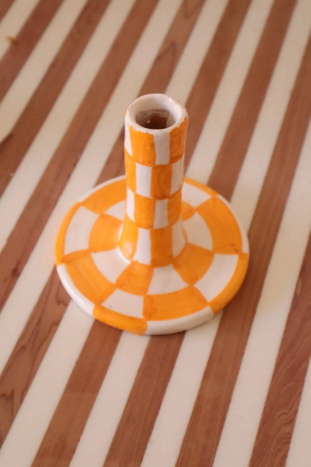 Pair of yellow and white checkered ceramic candlesticks