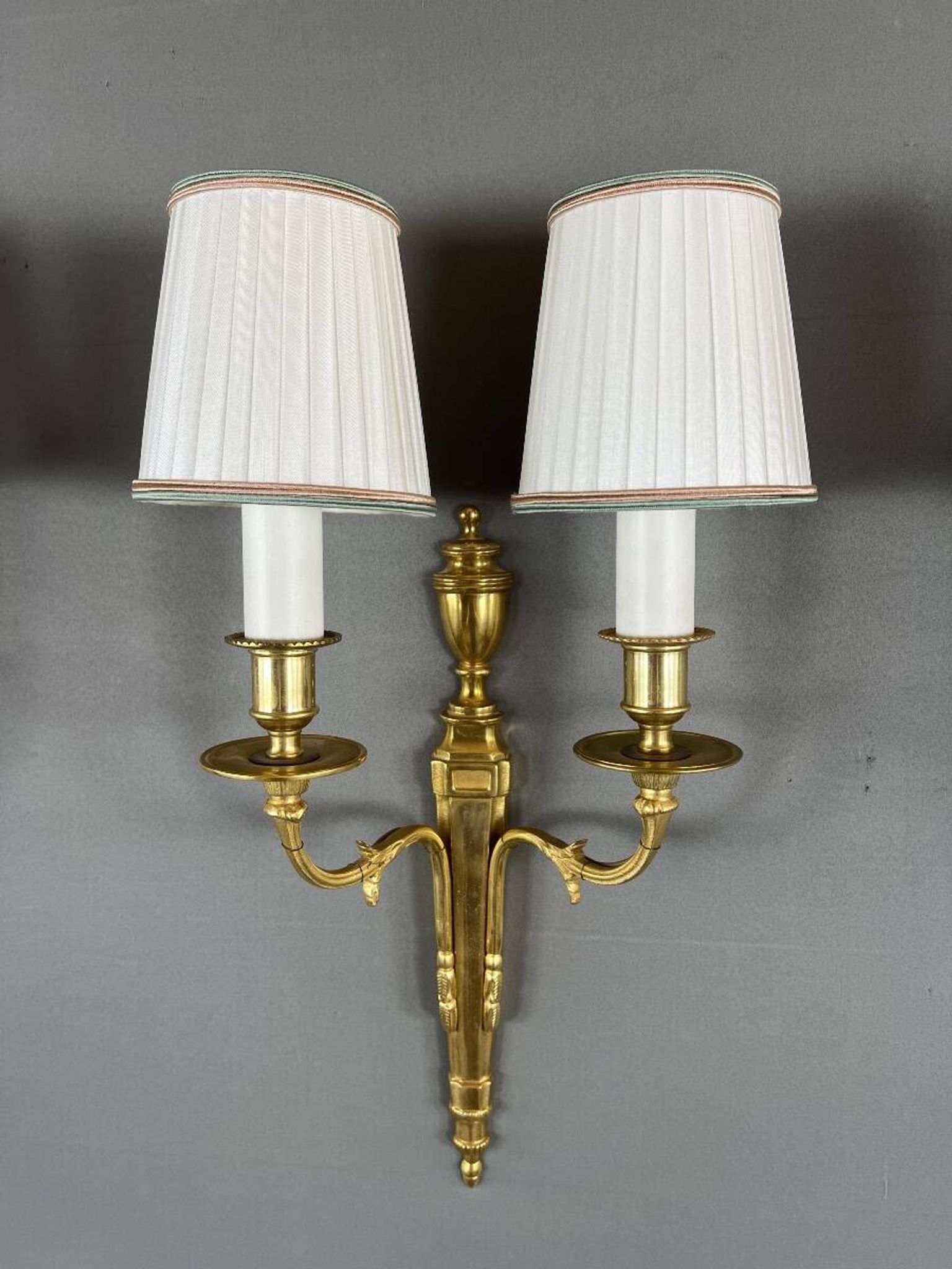 Set of three Louis XVI style wall sconces in gilded bronze, 20th century.