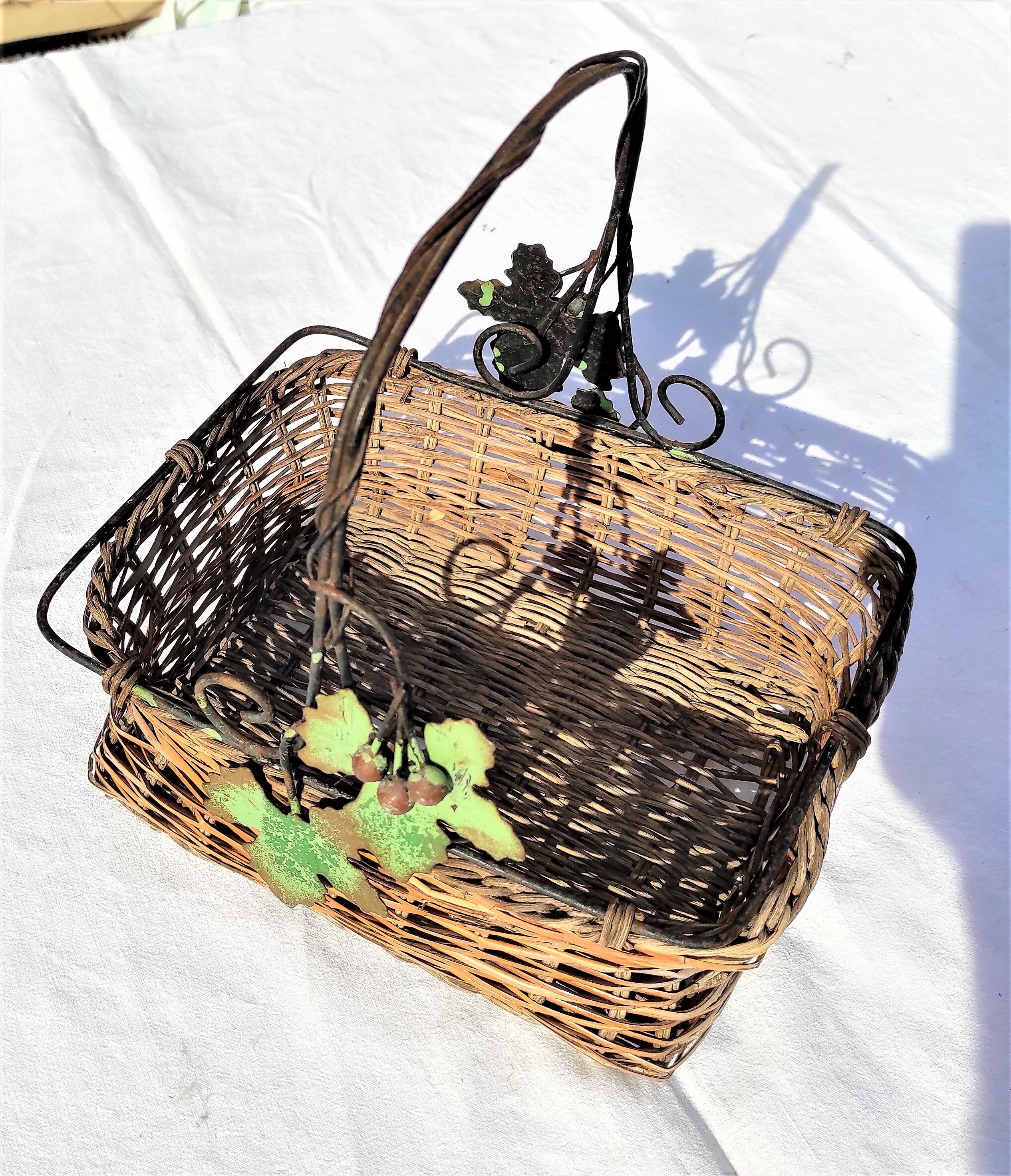 Old wicker basket decoration vine leaves and grapes