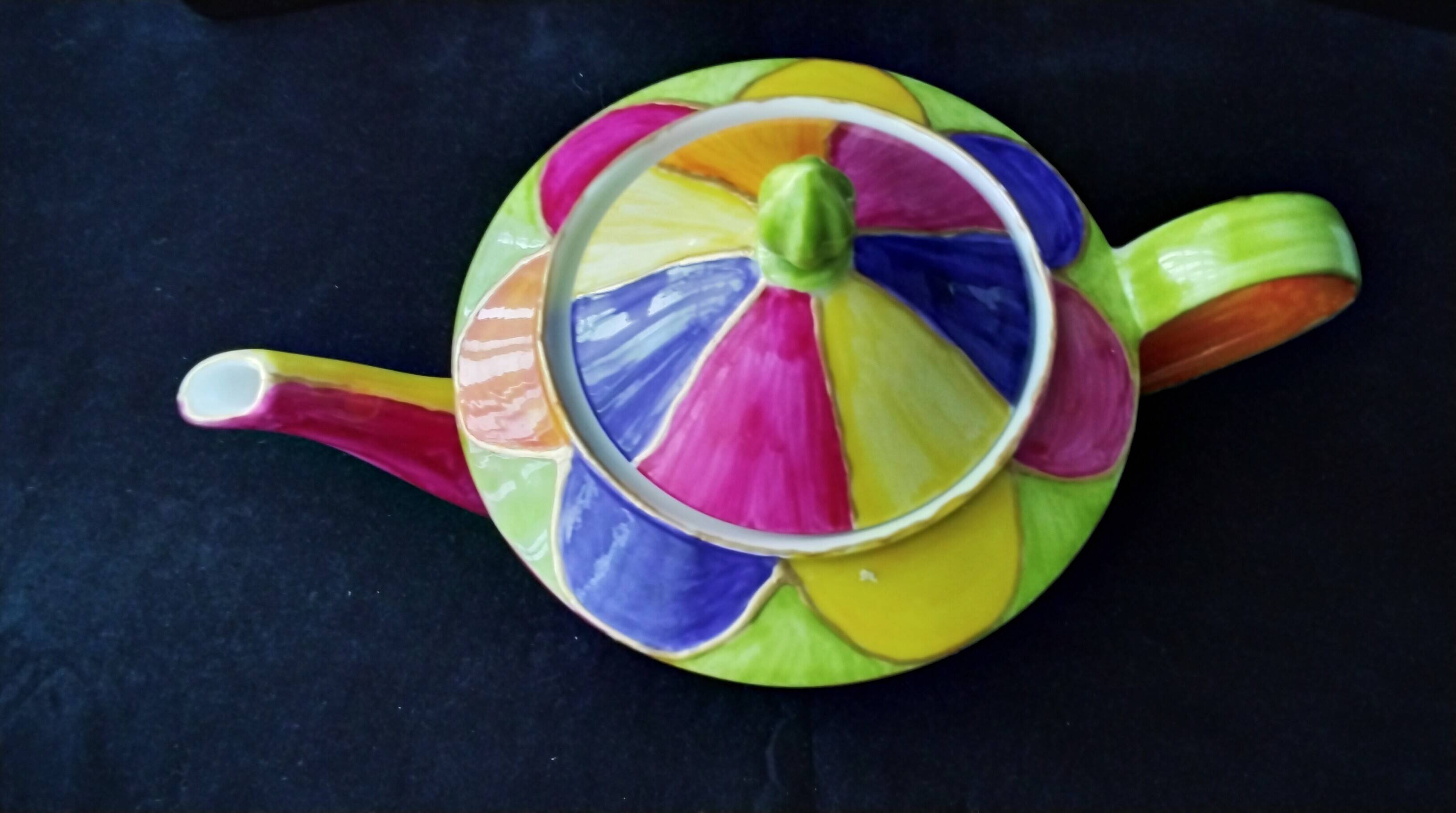 Polychrome porcelain teapot hand-painted.