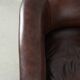 Dark cow leather club armchair with a stylish design in English style