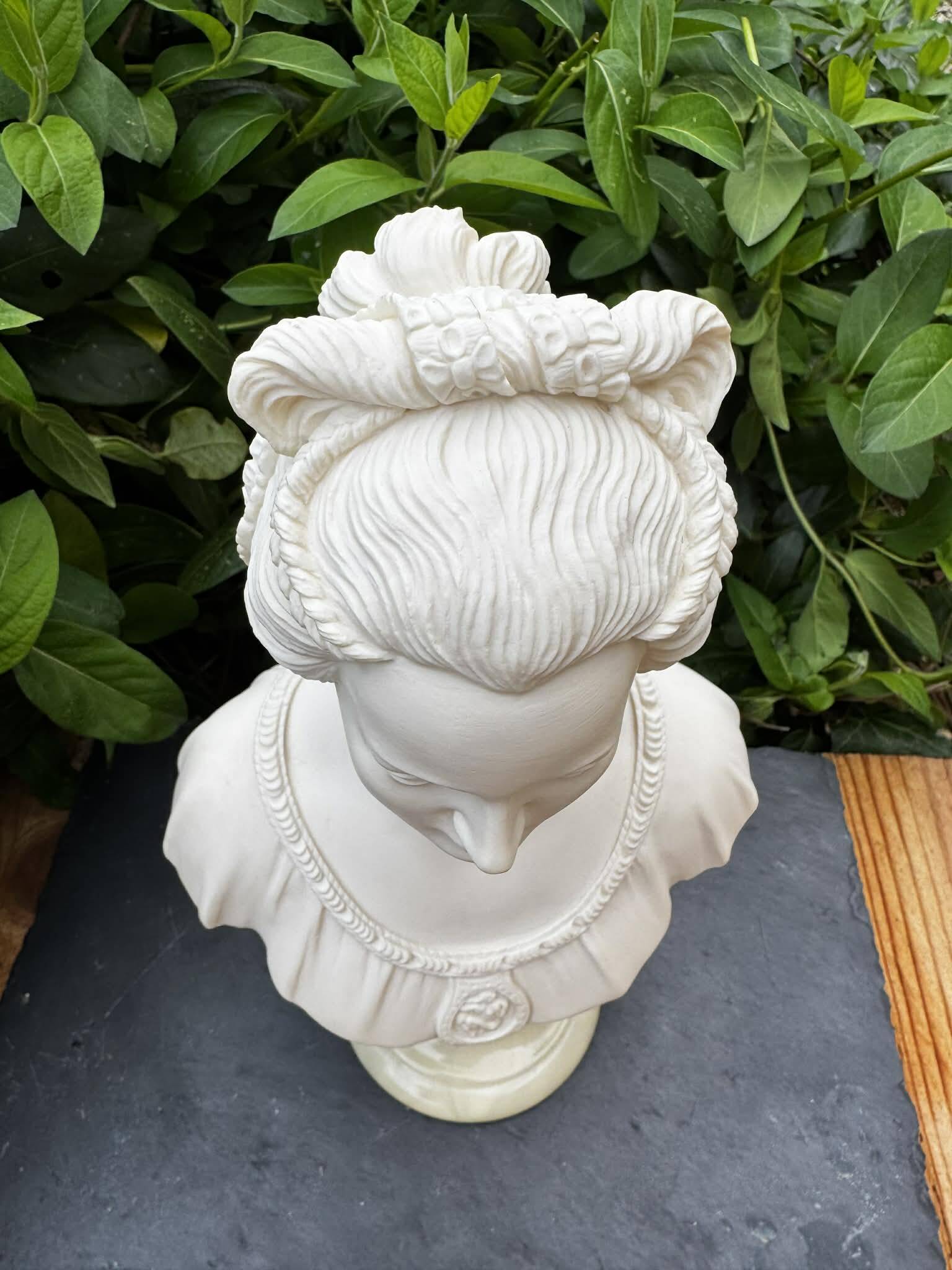 Alabaster bust of a woman signed Arnaldo Giannelli dated 1980.
