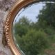 Miroir ovale vintage doré à décor floral et verre biseauté – 58 × 48 cm