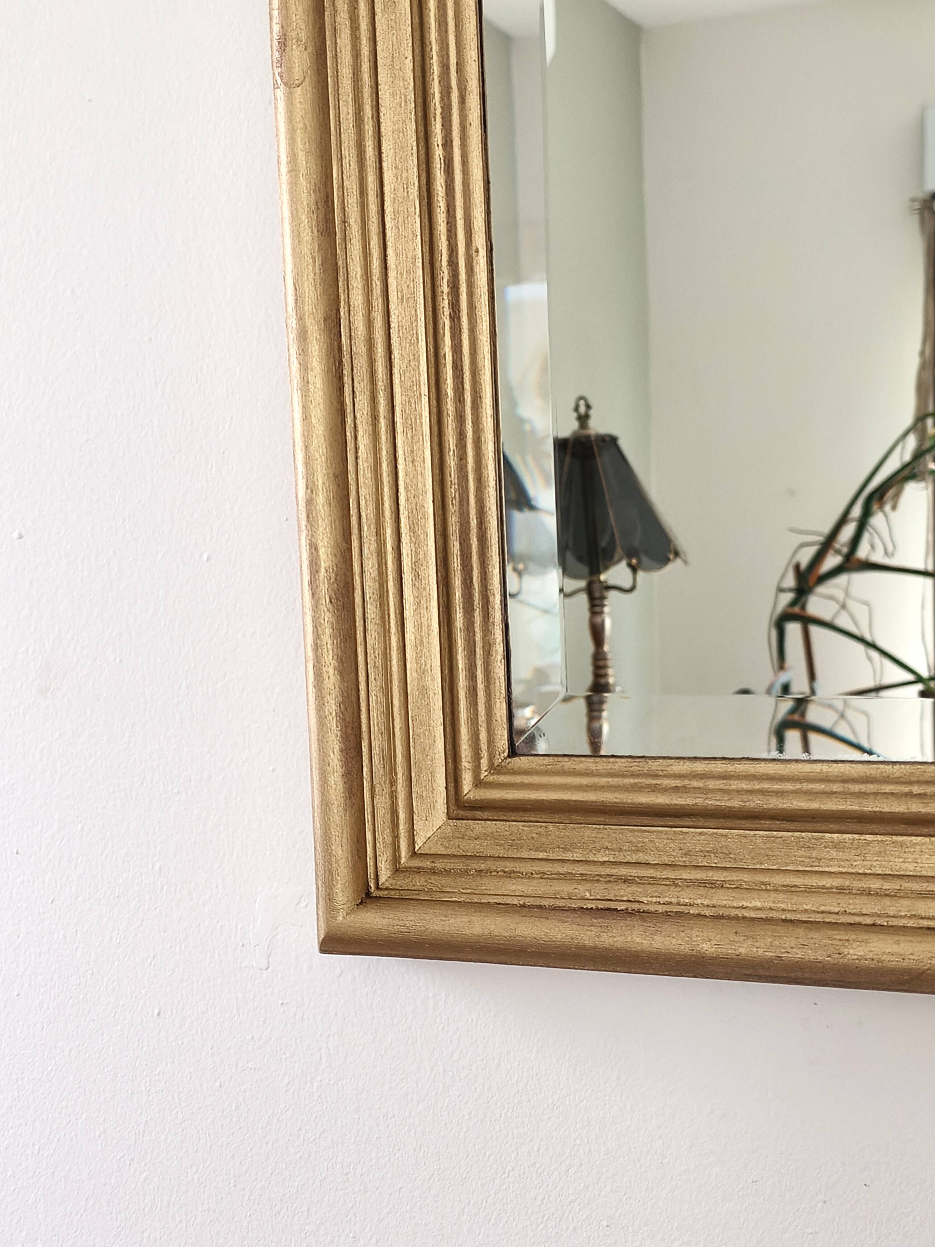 Large gold-framed mirror with bevelled glass.