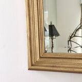 Large gold-framed mirror with bevelled glass.