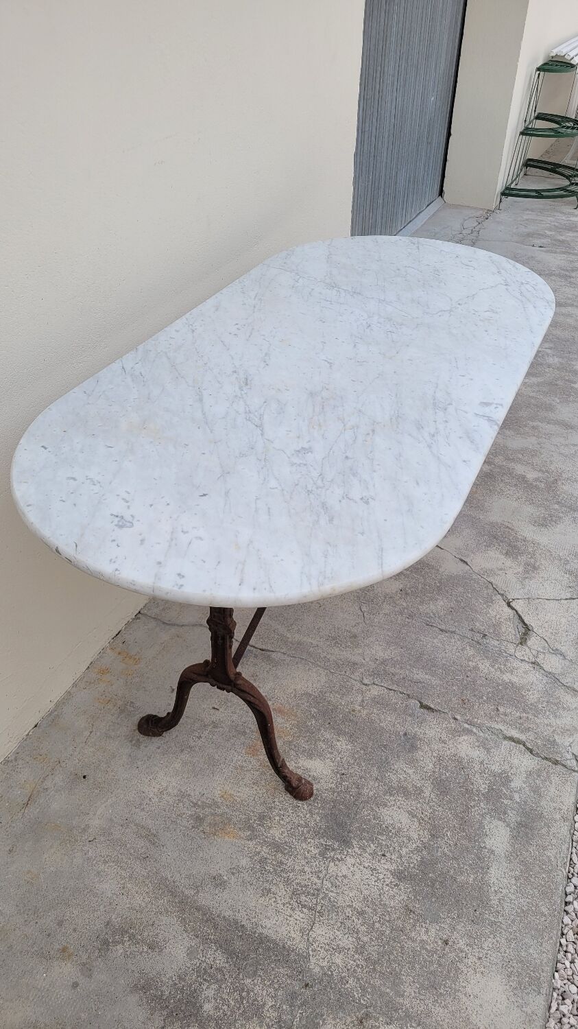 Restaurant bistro table in oval marble and decorated cast iron bases -1m51