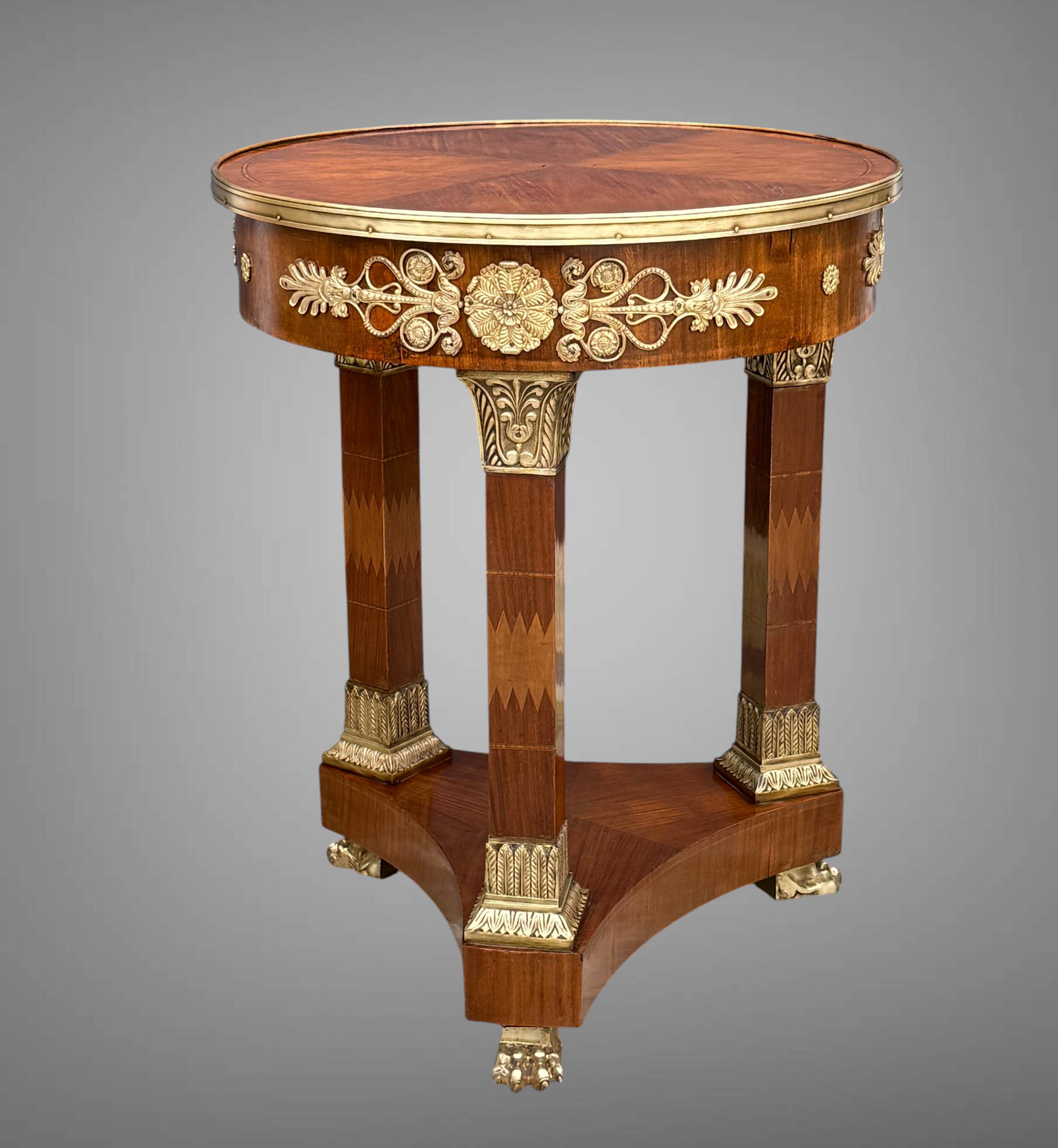 Circular gueridon empire of the 19th century in marquetry ornamented with gilt bronze
