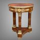 Circular gueridon empire of the 19th century in marquetry ornamented with gilt bronze